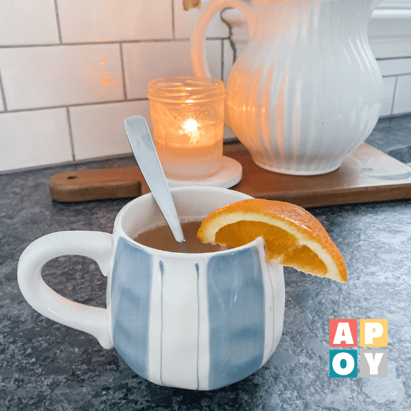 mug filled with orange tonic on countertop