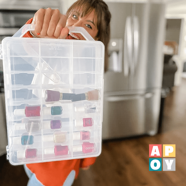 woman holding plastic nail polish storage container in kitchen