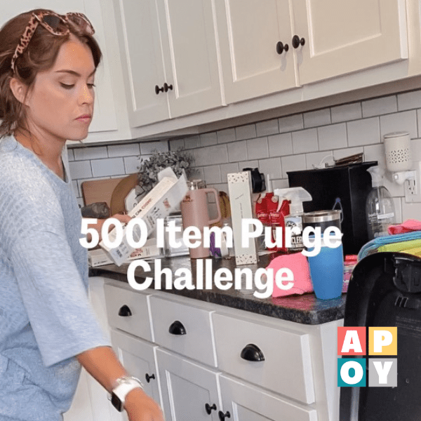 woman in kitchen cleaning counter tops 500 item purge challenge
