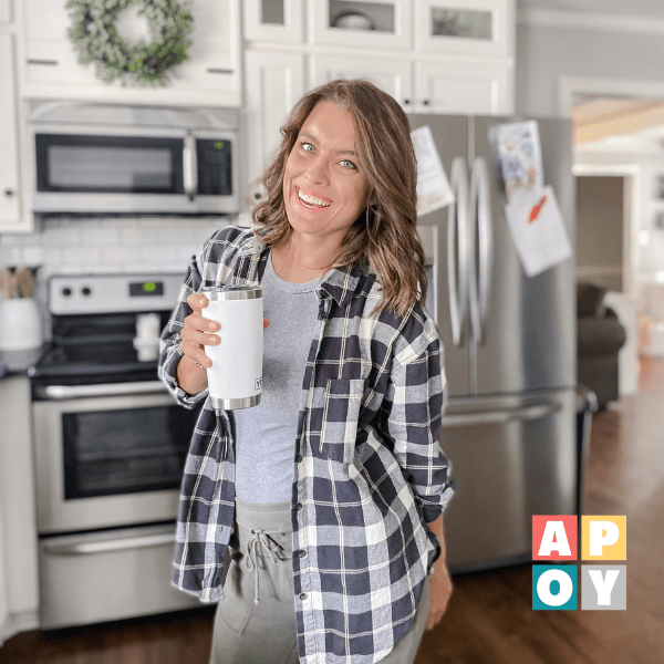 woman standing in kitchen with coffee mug